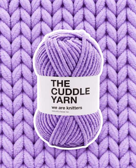 The Cuddle Yarn Lilac skein on matching knit background