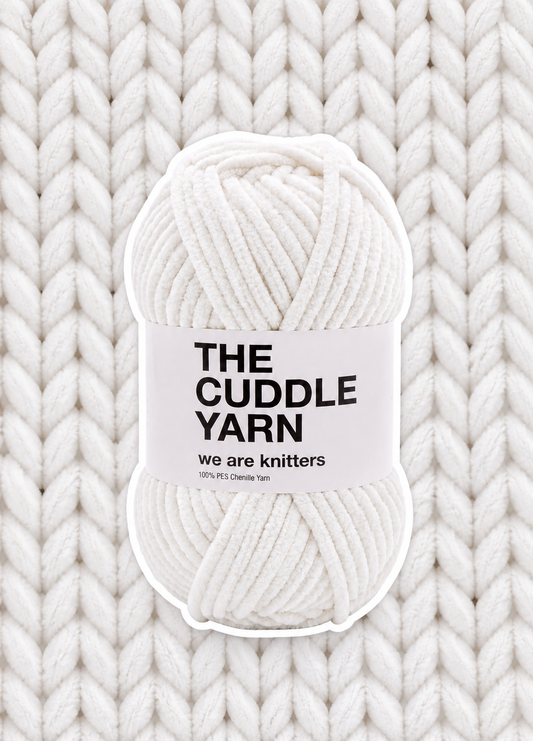 The Cuddle Yarn White skein on matching knit background